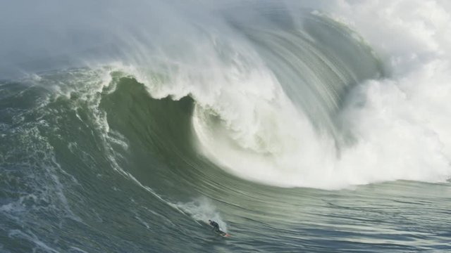 Aerial confident surfer on big wave Mavericks America