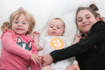 Close up Portrait of Three Beautiful Sisters, One Cute Toddler Girl , 3 Month Old Baby Girl, 7 Years Old Girl, Best Friends Forever, Happy  family concept, The most Beautiful Girls, Princesses 