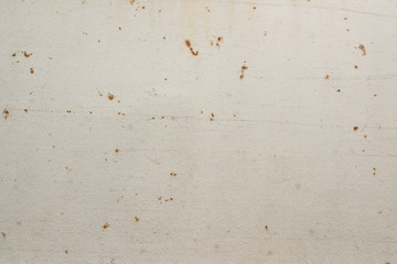 Abstract textured white wall with small rust stains