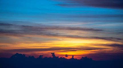 sun setting over clouds views from airplane