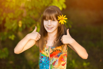 Portrait of adorable girl, showing thumbs up