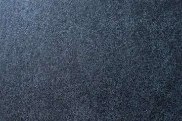 Dark granite. The texture of natural stone slabs for facing the facade of the building.