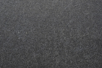 Dark granite. The texture of natural stone slabs for facing the facade of the building.