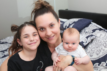 Close up portrait of Young Beautiful Mother with two daughters, Cute 3 Month Old Baby Girl , 7 Years Old Girl, Happy Family, Happy Mother’s Day, Best Mother Concept, The Most Beautiful Girls in the wo
