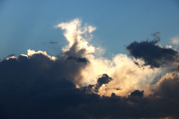 Naklejka na ściany i meble View of a dark cloud during sunset