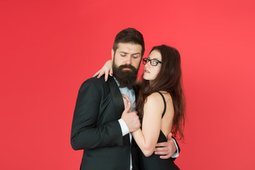 Lets dance tonight. Elegant couple in love tender hug dancing red background. Feel rhythm of heart. Happy together. Man in tuxedo and woman black dress dancing at party. Passionate couple dancing