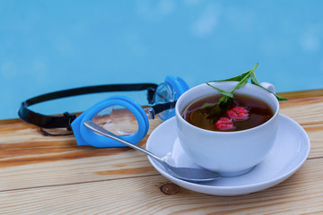 Cup of tea with mint and raspberry in the pool