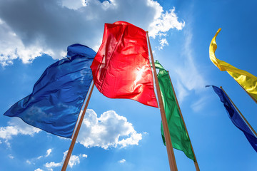 Colorful flags in the wind against the blue sky