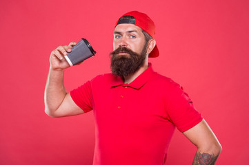 Barista recommend caffeine beverage. Barista job position. Coffee shop staff wanted. Barista prepared drink for you. Cheerful barista. Man bearded hipster red cap uniform hold paper coffee cup