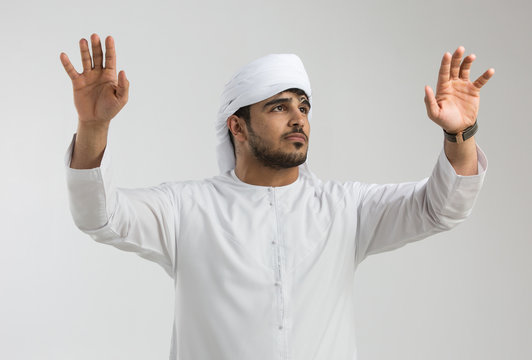Emirati man working on futuristic screen.