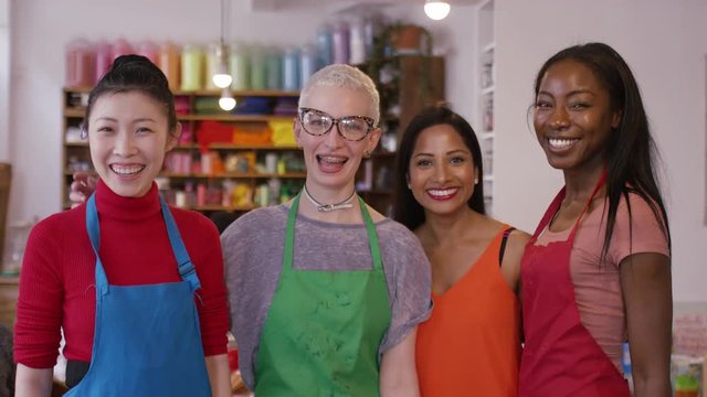 Portrait of diverse smiling women in an art shop looking to camera 