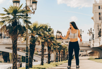 Urban girl roller skating on the sunny day in downtown
