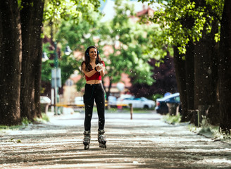 Fototapeta premium Active woman roller skating in park