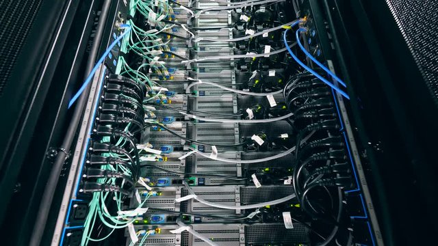 Electrical wires plugged into functioning servers. Network and data servers concept.