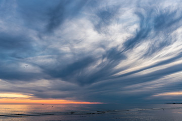 Fototapeta na wymiar Beautiful sunset on the sea with storm clouds.