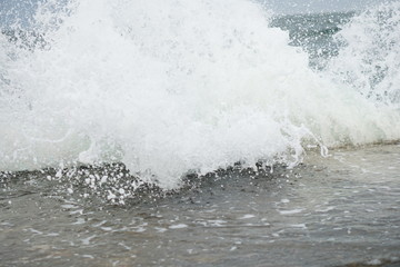 Fototapeta na wymiar storm, big waves on the coast, splashes of salt water