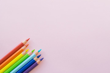 Color pencils on Pink background, copy space. Office supplies, back to school.