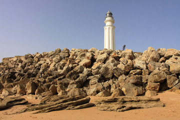 LANDSCAPE ON THE COAST OF CADIZ WITH ROCKS AND LIGHTHOUSE OF TRAFALGAR