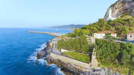 East side of Sicilian historic town of Cefalu, with white lighthouse, sea port, promenade .