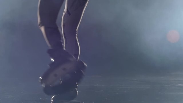 Strong legs doing exercises in kangoo jumps shoes. Close-up slow motion