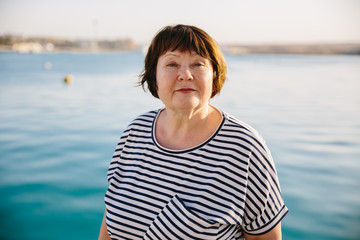 Senior woman relaxed and happy at sea sunset