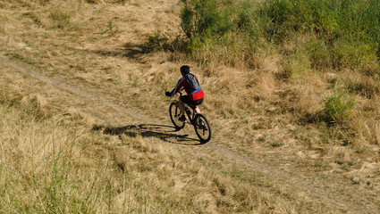 Ciclista no meio do campo a fazer BTT