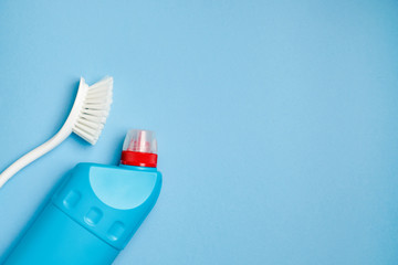 Plastic brush for washing dishes and blank toilet cleaner bottle. Household cleaning accessories.