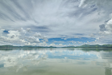 The Islands and mountains on reservior in dam. On the day of clouds and cloud reflection in the beautiful water of  KaengKrachan National Park.