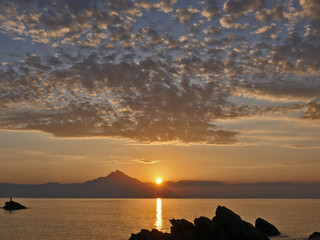 sunrise over sea and mountain