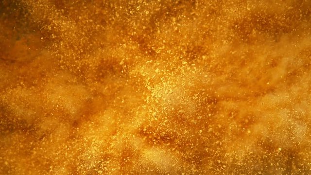Super slow motion of golden powder explosion. Filmed on high speed cinema camera, 1000fps.