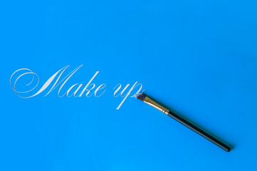 Makeup brush on a blue background