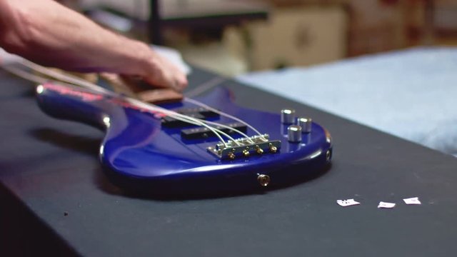 Unscrewing parts of a bass guitar for repairing