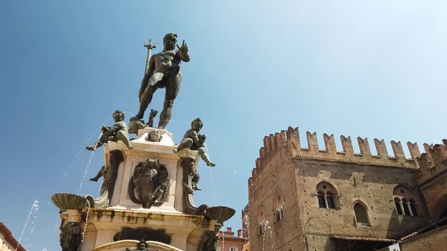 Neptune 1500s bronze statue fountain with gothic architecture background in Piazza Maggiore central square of Bologna town in Italy.