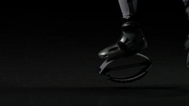 Close-up legs jumping in gray kangoo jumps shoes, slow motion