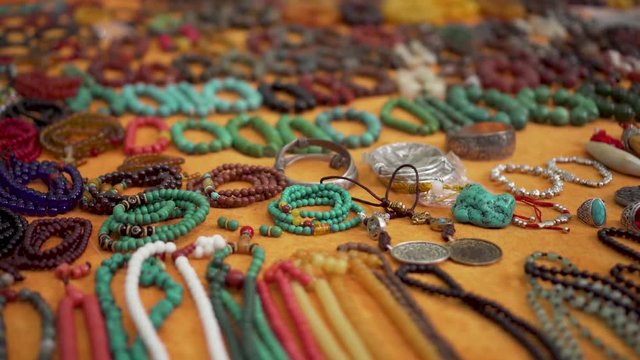 Asian Flea Market Seller Shows Bracelets
