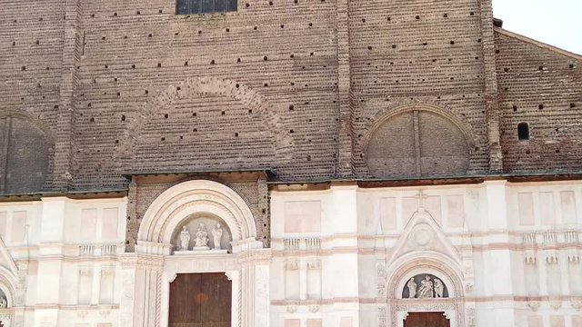 Facade of Balisica of San Petronio on the Piazza Maggiore or main square, Bologna, Italy. It is the largest church built in bricks in the world. SLOW MOTION
