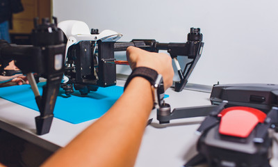 Closeup shot of man working on assembling new surveillance system using quadcopter drone with...