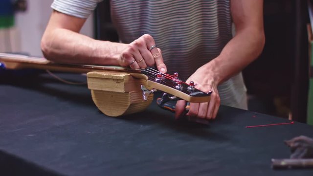 Luthier change strings of bass guitar