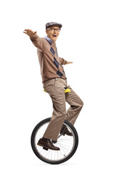 Senior man riding a mono-cycle and balancing with hands © Ljupco Smokovski