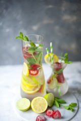 Cold summer drink with mint, strawberry and lemon