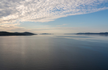 Calm Adriatic sea with islands off the coast of Croatia as ship approaches port of Zadar