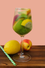Glass of soft drink with lemon, lime, mint and nectarine. Summer  refreshing lemonade beverage.
