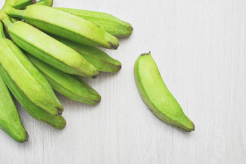 green bananas on white wooden table