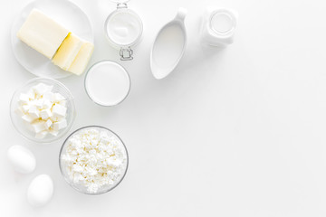 Eggs, butter, milk, yougurt, cottage for natural farm products yougurt on white background top view monochrome copyspace