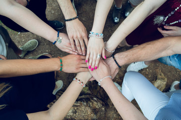 High angle view of group of young people holding hands together teamwork success friendship