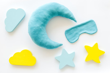 Sleep time concept with moon, stars, clouds, blindfolder on white background top view
