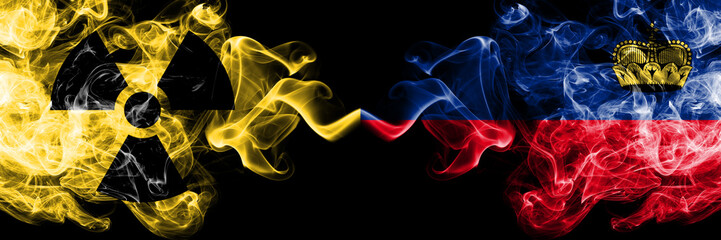 Liechtenstein, Liechtensteins vs nuclear smoky mystic flags placed side by side. Thick colored silky smokes combination of Liechtenstein, Liechtensteins flag and radioactive sign.