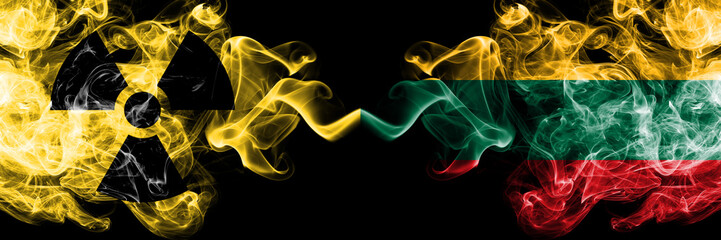 Lithuania, Lithuanian vs nuclear smoky mystic flags placed side by side. Thick colored silky smokes combination of Lithuania, Lithuanian flag and radioactive sign.