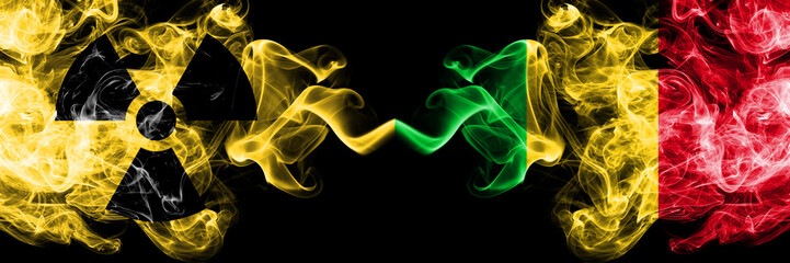 Mali vs nuclear smoky mystic flags placed side by side. Thick colored silky smokes combination of Mali flag and radioactive sign.