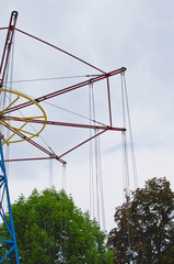 A long view of the old frame of the swinging ride at the old amusement park in the city. 